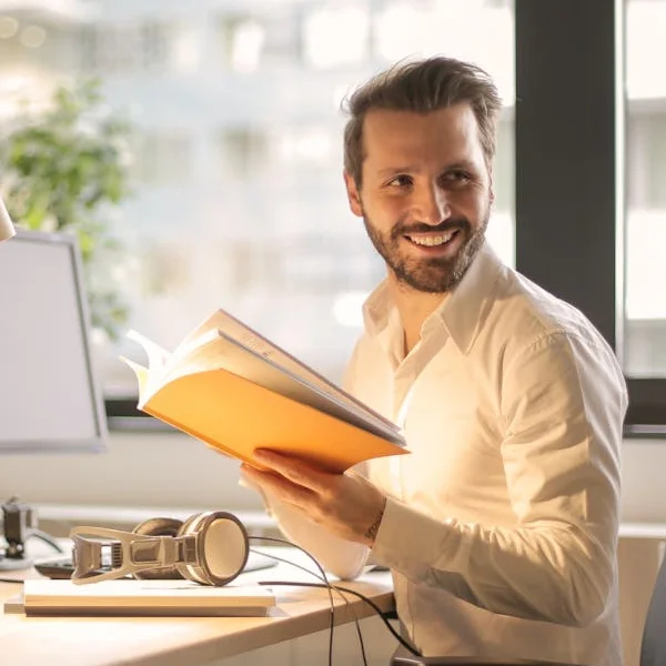 The Right UK Cloud Backup Choice for UK SMEs Man smiling while working in an office